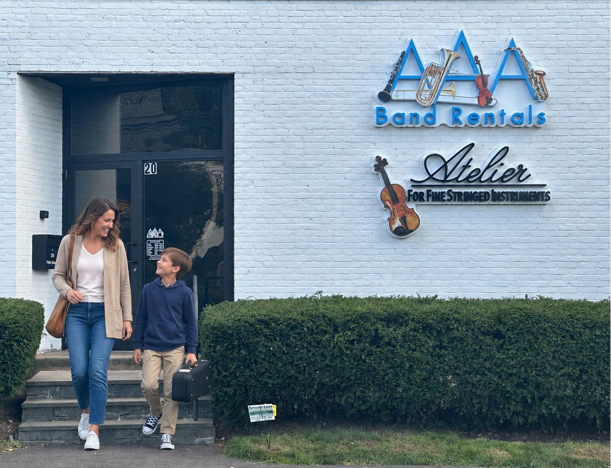 Woman and child walking in front of a building with 'AAA Band Rentals' signage.