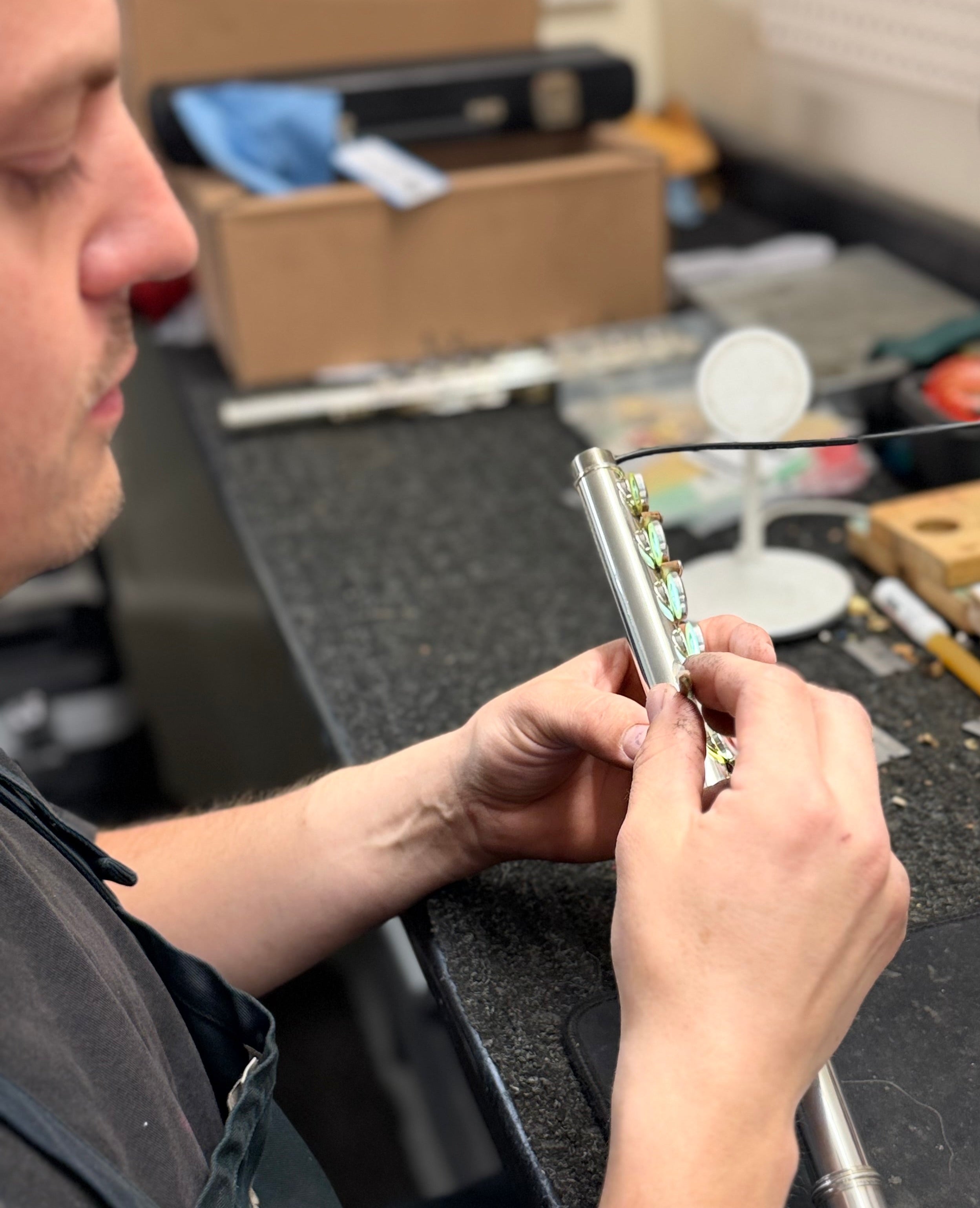 Repair technician repairing a Yamaha flute in Norwalk, CT.